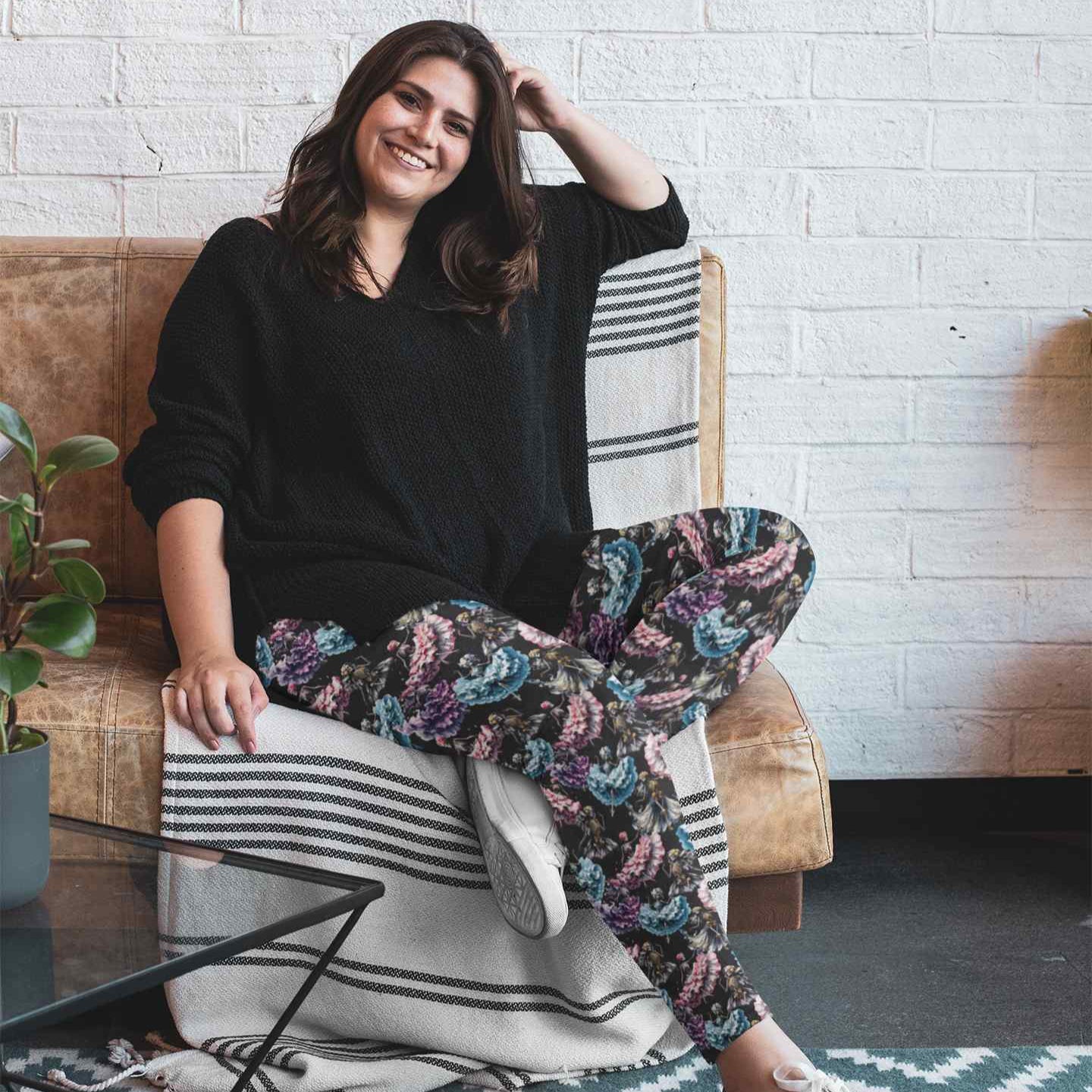 plus size lady wearing Danse Macabre Skull Leggings featuring skeletons dancing in gothic attire with muted grey and purple tones on a moody background.