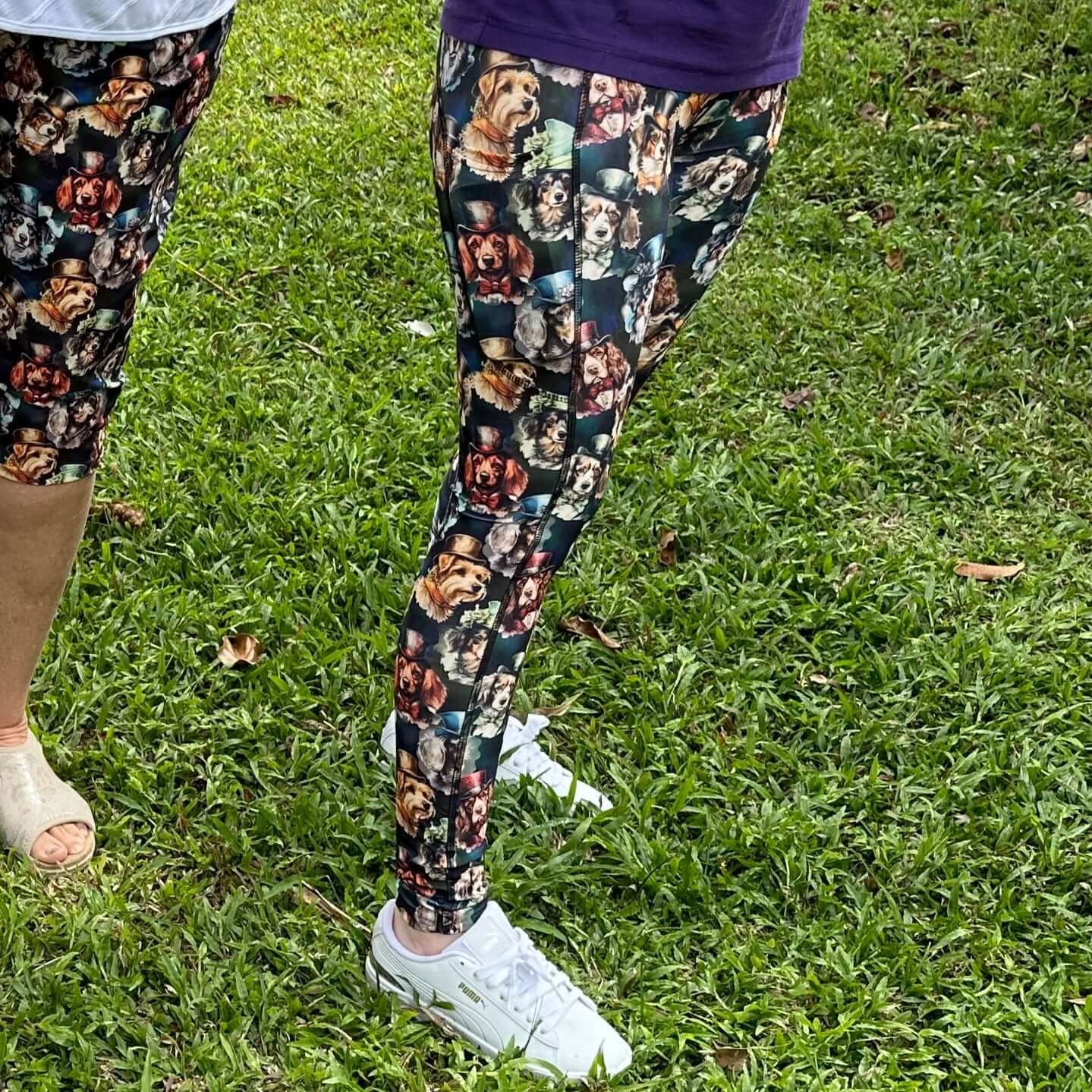 Person wearing leggings with dog pattern on grass