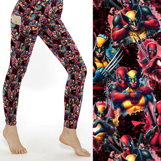 Black leggings with a pattern resembling Deadpool and Wolverine in various playful poses. A side pocket holds a phone, and the right side of the image provides a close-up view of the vibrant comic-style design, featuring splashes of red, yellow, and black throughout. The leggings are high-waisted and full-length