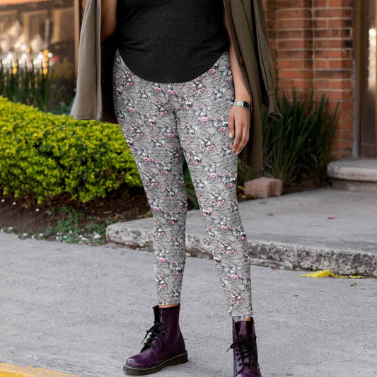 Person wearing Fairy Gothmother Skull full length grey leggings and purple boots on a sidewalk by Nikki Whoops Boutique.
