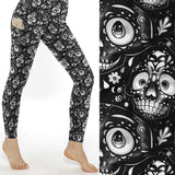 Grin Reaper Skull Print Leggings With Pockets featuring black and white cartoon-style sugar skulls on buttery-soft full-length leggings with deep side pockets.