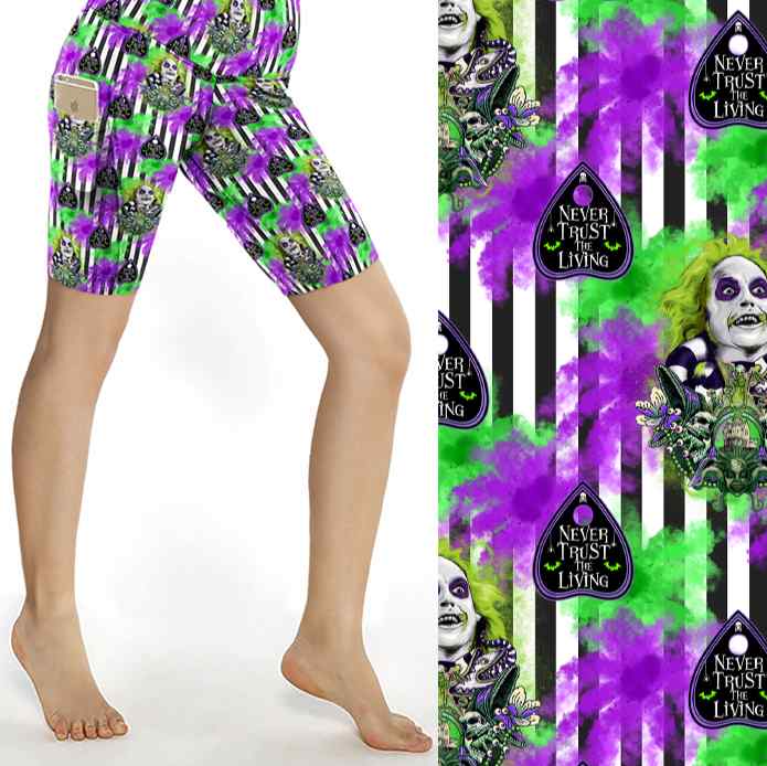 It's Showtime Beetlejuice Shorts featuring Beetlejuice image with text reading Never Trust the Living on a vibrant green, purple black and white striped pattern.