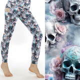 Leggings with pastel pink, lavender, and blue roses intertwined with detailed skull designs on a soft cloudy background.