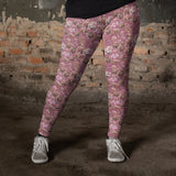 pink-and-gold-steampunk-leggings-on-model-leaning-against-a-wall