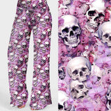 Mourning Glory Skull lounge pants with pink floral background and white skulls in a gothic floral print.
