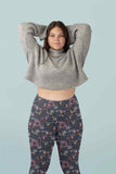 studio image of a girl wearing punk unicorns on a navy harlequin background capri leggings