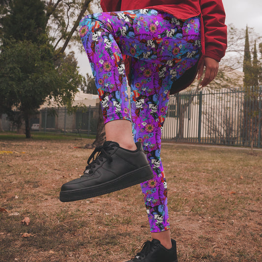 Person wearing colorful floral pants and black sneakers in an outdoor setting