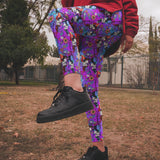 Person wearing colorful floral pants and black sneakers in an outdoor setting