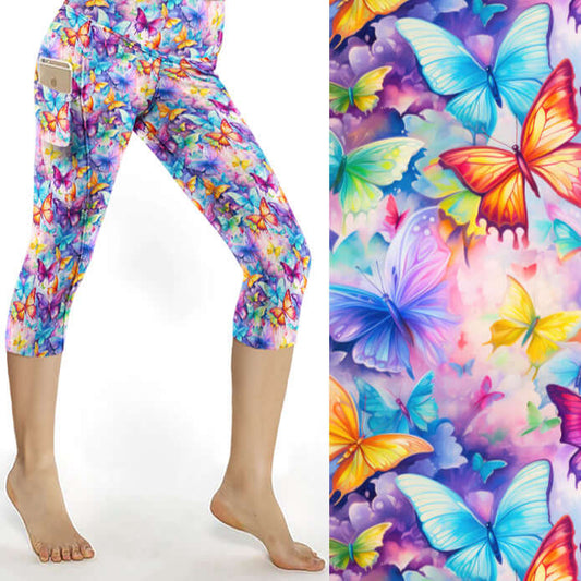 Colorful butterfly-patterned leggings worn by a person on a white background