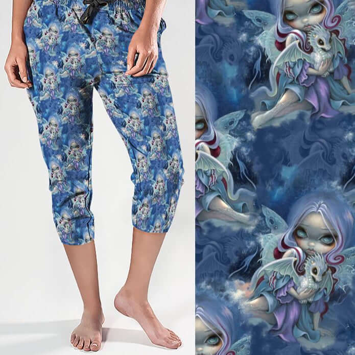 mockup of Wintry Dragonling Strangelings capri joggers from artist Jasmine Beckett-Griffith featuring an ethereal gothic-eyed fairy holding a baby dragon, set against a magical winter night sky in deep blues and lilac by Nikki Whoops Boutique. Nikki Whoop