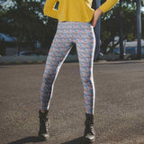 Person wearing blue patterned leggings and yellow top outdoors