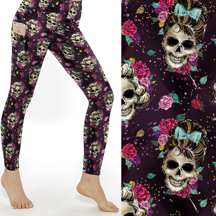 Leggings with Audrey Hepburn Marilyn Monroe skulls, roses, and bows on a dark background; close-up shows detailed floral accents and designs.